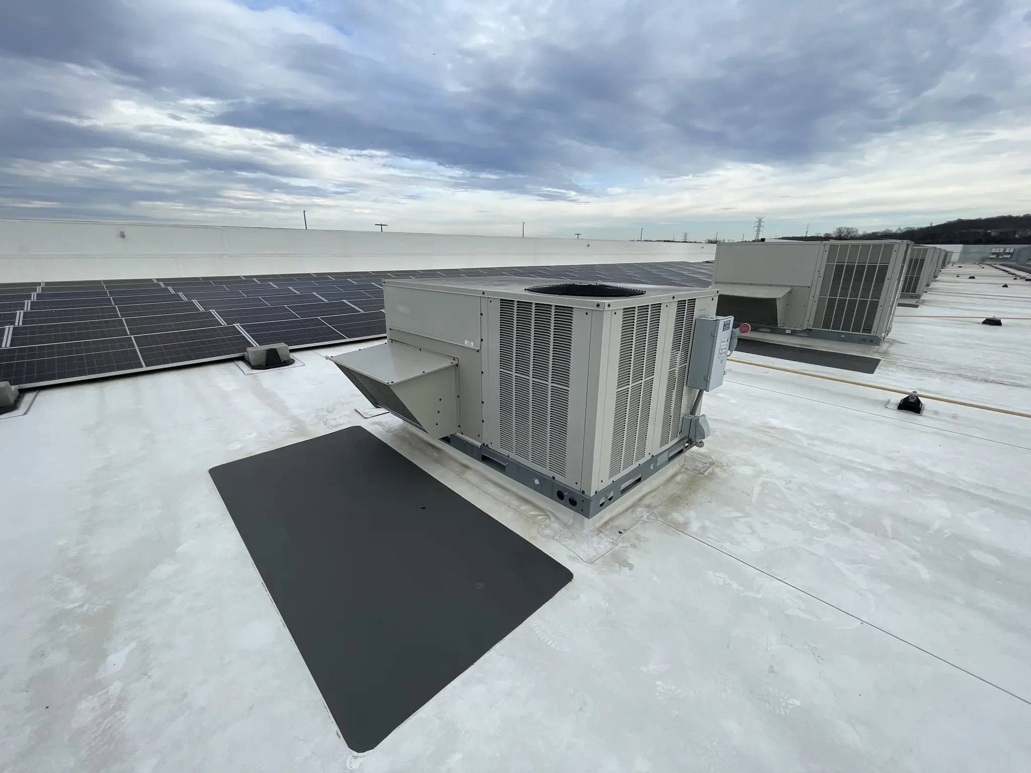 Completed commercial rooftop HVAC installation with multiple packaged units