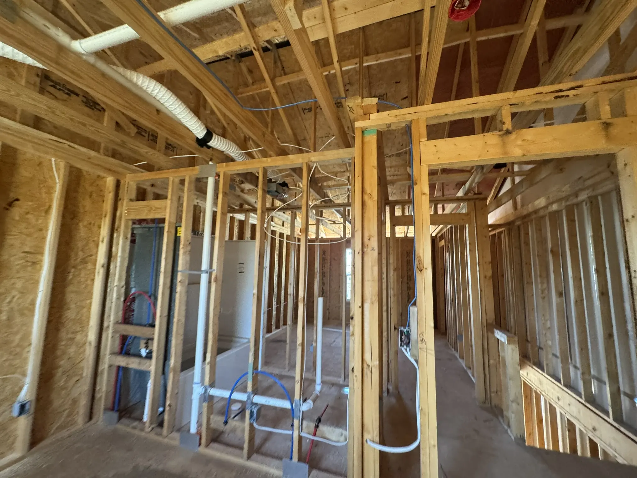Residential plumbing rough-in installed through new wood framing